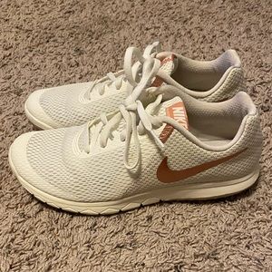 Women’s white and rose gold Nike shoes
